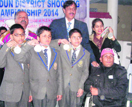 Students of The Aryan School, who won medals during the 4th District Rifle Shooting Championship held at the Jaspal Rana shooting range, near Dehradun, on Monday