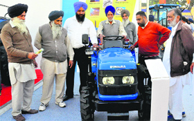 Farmers look at a mini tractor at the CII Agro-Tech Fair at Parade Ground in Sector 17, Chandigarh, on Tuesday.