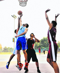 Players in action during a basketball match between Government College, Ludhiana, and PU Campus at Panjab University in Chandigarh on Tuesday.