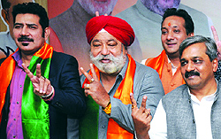 Singer Shankar Sahani (L), Harsharan Singh Balli (C) with BJP Delhi unit president Satish Upadhyay (R) at a function in New Delhi on Tuesday