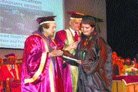 Vidya Stokes, Minister for  Irrigation and Public Health and Information and Technology, confers a degree on a student at the Dr YS Parmar University of Horticulture and Forestry at Nauni on Tuesday