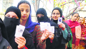 Women wait in queue to cast their votes in the Doda Assembly segment on Tuesday.