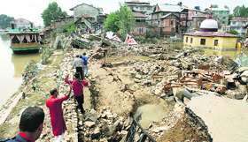 People walk along the breached Jhelum bank in Srinagar.