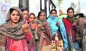 Voters show their inked finger after casting their votes at a polling station in Batote, Ramban, on Tuesday.