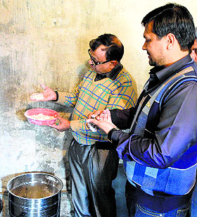 Health Department officials inspect food samples at a school in Ludhiana on Tuesday. 