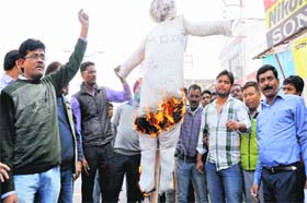 Shopkeepers of Chakrata Road burn an effigy of the state government in Dehradun on Tuesday