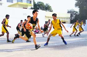 Players of Woodstock School and Hilton School battle for the ball during the U-15 District Basketball Championship at Doon International School in Dehradun on Tuesday
