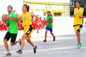Players of Woodstock School, Mussoorie, and St Mary School vie for the basket