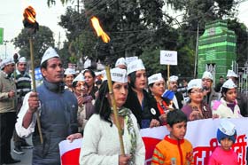 Aam Aadmi Party workers hold a candle march against corruption at Gandhi Park in Dehradun on Tuesday