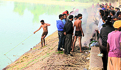 Volunteers of NGO Sahara Jan Sewa search for the man whose clothes were found on the banks of Lake No. 3 of the Guru Nanak Dev Thermal Plant in Bathinda on Wednesday