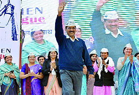 AAP convenor and former Delhi Chief Minister Arvind Kejriwal waves to the gathering during a session on Women Dialogue' ahead of the assembly elections in New Delhi on Wednesday. 