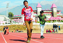 Physically challenged children take part in a race during a sports meet in Dharamsala on Tuesday