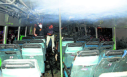 Locals douse flames that caught the bus near Una bus stand on Wednesday