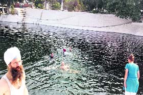 Sikh devotees from European countries take bath in holy Bein at Sultanpur Lodhi in Kapurthala on Wednesday