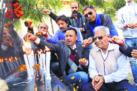 Members of the J&K Freedom Fighters Association pay tributes to 26/11 martyrs by lighting candles in Jammu on Wednesday. 