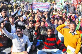 Residents of the Salt Assembly constituency in Almora protest in support of their demand in front of the Vidhan Sabha in Dehradun on Wednesday