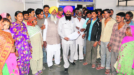 Residents of hutments in New Shakti Nagar outside the DC office in Bathinda on Thursday.