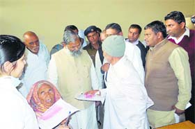 Health Minister Anil Vij talks to a patient during a visit to the civil hospital in Kaithal on Thursday