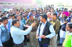 Police and district administration officials talk to the agitating students outside the ITI in Sirsa on Thursday