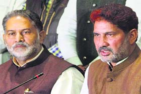 Haryana BJP president Subhash Barala (right), addresses a press confrence in Chandigarh on Thursday as Education Minister Ram Bilas Sharma looks on