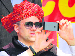 Chief Minister Omar Abdullah takes a selfie during a rally in Jammu on Thursday.