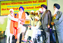 Office-bearers of Guru Nanak International Education Trust honour Avtar Singh Makkar (second from left) during a function in Ludhiana