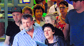 The parents of Phil Hughes, father Greg and mother Virginia, and other family members leave the hospital in Sydney on Thursday.