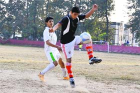 Players of SGRR Bindal (black) and Summer Valley (white) battle for the ball during a match at Ambedkar Stadium in Dehradun on Thursday