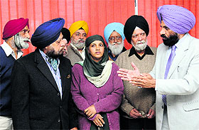 Victims of the 1984 anti-Sikh riots meet Dr Ajaib Singh (extreme right), Member, National Commission for Minorities, in Chandigarh on Friday. 