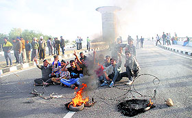 Residents block the Fourth Bridge on the Tawi in Jammu on Friday.