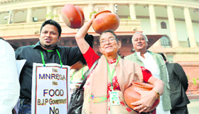 Trinamool Congress MPs carry earthen pots during their protest over MNREGA at Parliament in New Delhi on Friday.