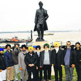 Members of Guru Nanak Darbar Gurdwara, Gravesend, pose in front of the Sikh soldiers statue in London